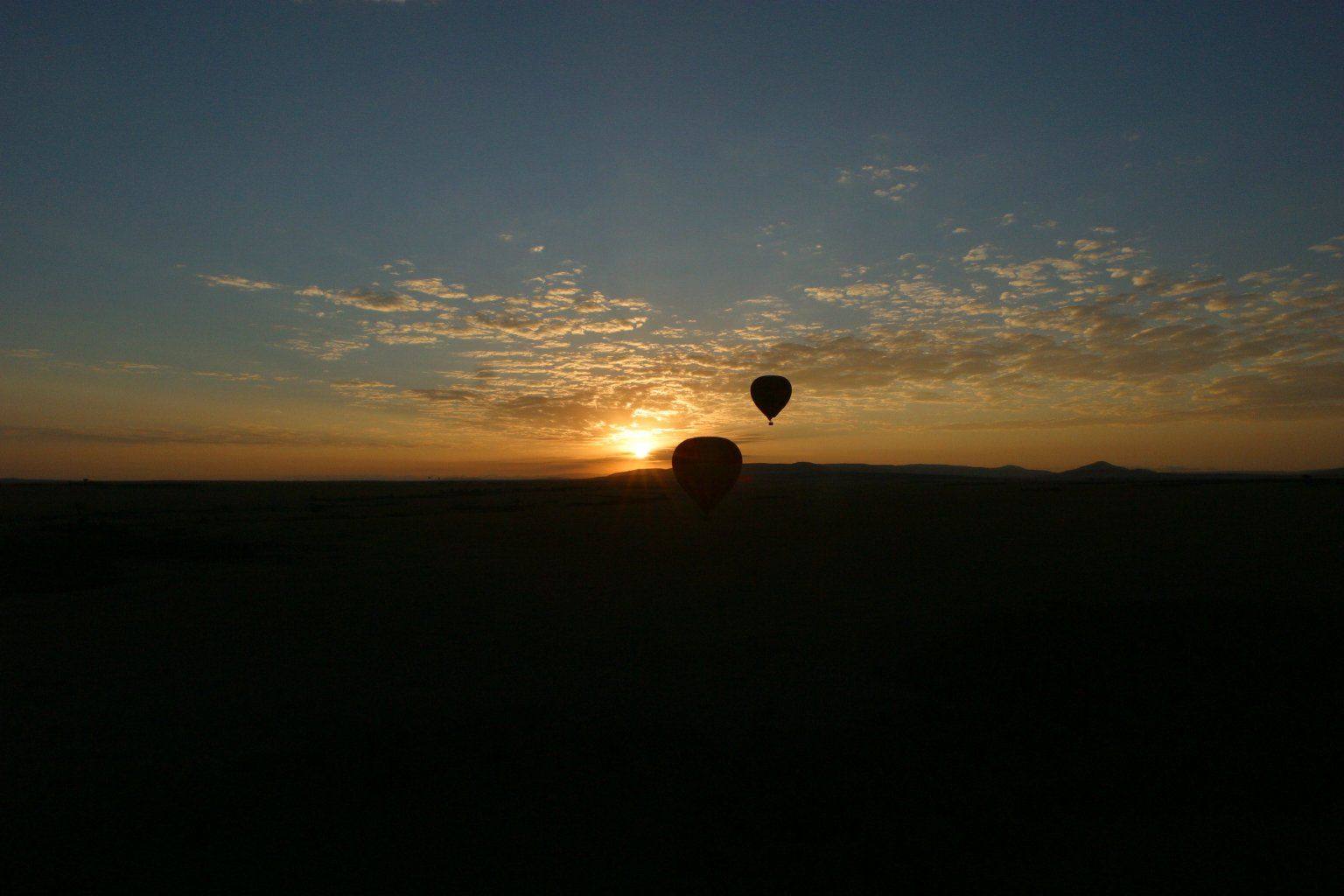 Hot air balloon at dawn over the Masai Mara plains