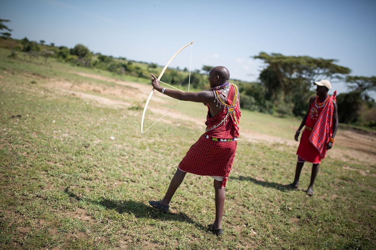 A Maasai guide demonstrating the traditional bow